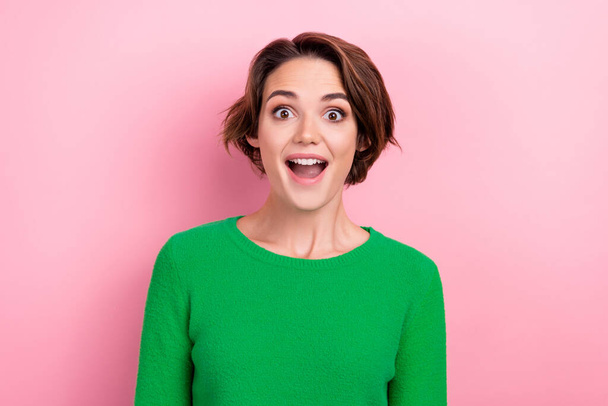 Photo of young funky girl bob brown hair wear stylish green pullover shocked crazy cheap discount offer isolated on pink background. - Foto, Imagen