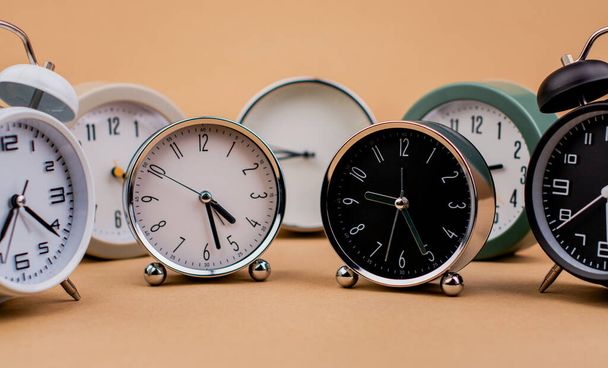 Wekker. Mooie moderne klok ligt op papieren achtergrond. time clock time standstill time off work werken met time time concept - Foto, afbeelding
