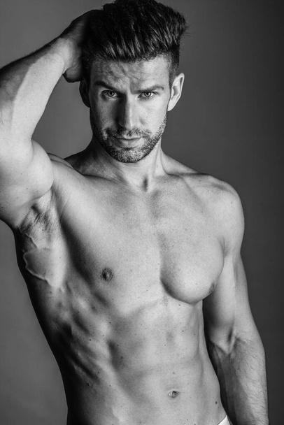 Black and white photo shoot of handsome man with perfect body. - Photo, Image
