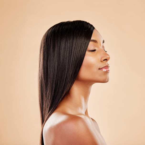 Beauty, hair care and profile of a woman in studio with natural glow and shine. Hairstyle, cosmetics and wellness of Indian person for hairdresser, makeup or salon results on a beige background. - Fotó, kép
