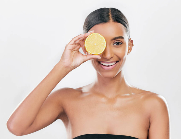 Happy, lemon and portrait of a woman for skincare, beauty glow or vitamin c for health. Smile, wellness and an Indian model or girl with fruit for diet isolated on a white background in a studio. - Fotografie, Obrázek