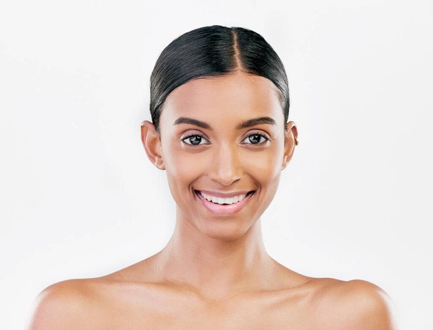 Beauty, face and portrait a happy woman with natural skin care isolated on a white background. Dermatology, makeup glow and cosmetics with Indian female model for facial shine and self love in studio. - Foto, Bild