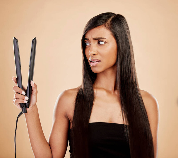 Hair straightener, woman is scared and beauty, hairstyle and appliance fail on studio background. Keratin treatment, problem with electric flat iron and female model, haircare crisis and treatment. - Valokuva, kuva