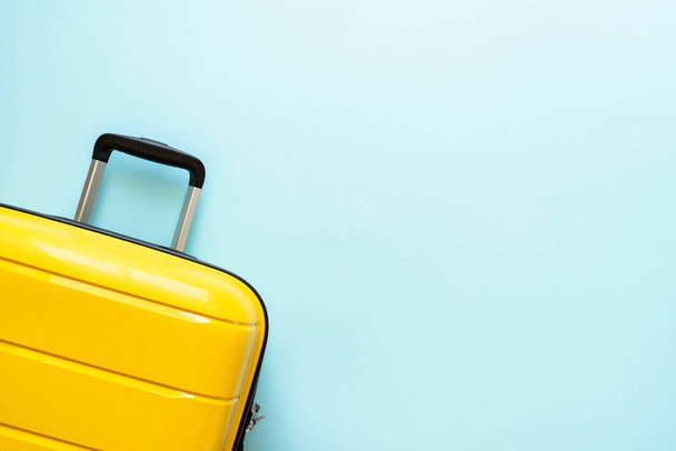 Suitcase on blue background. Travel concept. Happy Holidays, vacation. - Foto, Imagen