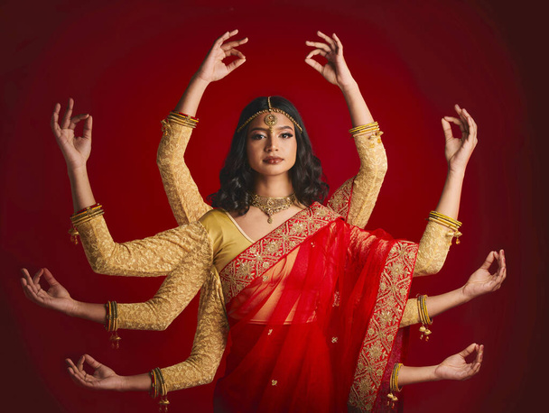 Indian woman, portrait and goddess with many hands in studio background with sari and jewellery. Mudra, girl and beauty face with meditation with dress or movement with culture or spirituality - Valokuva, kuva