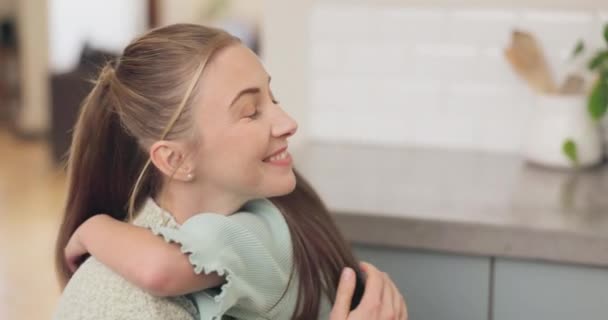 Mom, love and hug girl with a smile or bonding, support and care for child with happiness in home, house or kitchen. Mother, daughter and happy embrace with kid and quality time, together or family. - Footage, Video