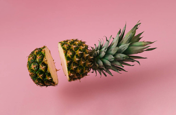 Fresh pineapple sliced on pastel pink background. Minimal fruit concept. Creative summer food idea. - Valokuva, kuva