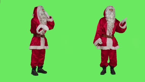 Romantic santa claus sends air kisses over greenscreen backdrop, acting flirty and sweet on camera. Father christmas showing romance gesture, spreading december holiday spirit. - Footage, Video