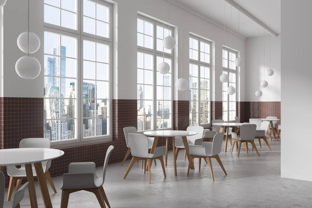 Corner of modern restaurant with white and brown tiled walls, concrete floor, round tables with white chairs and windows with cityscape. 3d rendering - Foto, Imagen