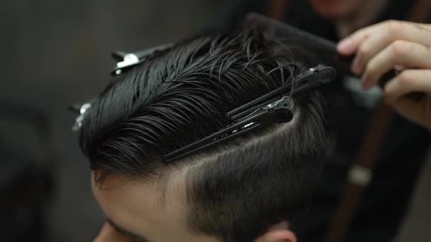 Detailní záběr profesionálního kadeřníka dokončovací doteky s nůžkami na vlasy mladých klientů, zpomalení. - Záběry, video