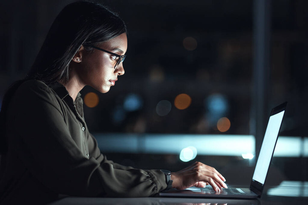 Laptop, research and business woman in coding, software development and programming for night cybersecurity. Computer, typing and screen reflection, focus and data analysis of programmer or IT person. - Foto, Imagen