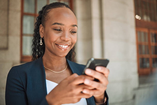 Phone, gps and a business black woman in the city, searching for directions or typing a message. Mobile, travel and commute with a young female employee looking for a location on a navigation app. - Photo, Image