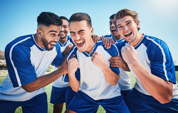 Football player, game and men celebrate together on a field for sports and fitness win. Happy male soccer team or athlete group with fist for challenge, competition or achievement outdoor on pitch. - Photo, Image