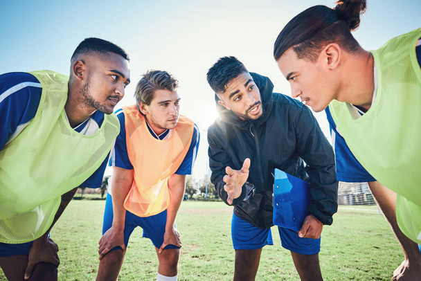 Soccer player, team talk and coach on field for tactics, sport and listen together for training, advice or fitness. Athlete men, group and mentor on pitch for exercise, football or teamwork in summer. - Photo, Image