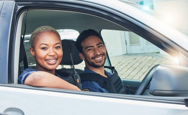 Police, driving together and portrait in car, smile and happy partnership to stop crime with teamwork in city. Black woman, man and patrol street in metro for justice, law and government surveillance. - Фото, зображення