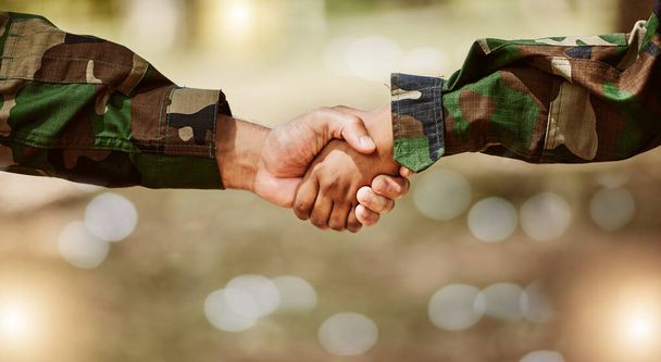 Army, camouflage and handshake for peace deal, problem solving and support for world solidarity. Partnership, connection and military people shaking hands in trust, agreement or mission cooperation - Photo, image