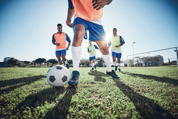 Football, men and exercise with action, field and wellness with workout goal, fitness and competition. Male players, guys and athlete with a challenge, soccer and sports with energy and training. - Φωτογραφία, εικόνα