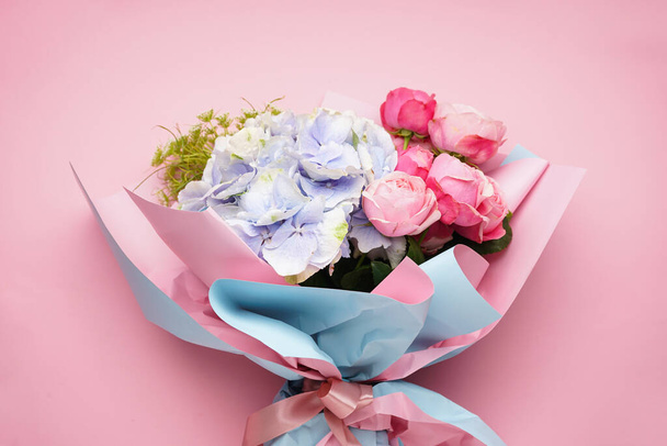 Букет пионских роз с гортензиями на розовом фоне, крупным планом. - Фото, изображение