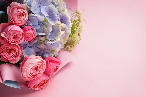 Bouquet of peony roses with hydrangea on a pink background, space for text. Flat lay. - Foto, imagen