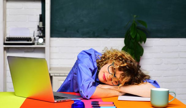 Back to school. Sleeping female student in classroom. Young student preparing for exams. Homework. Knowledge, education and learning concept. Tired overworked teacher woman sleep at desk. School job - Photo, Image