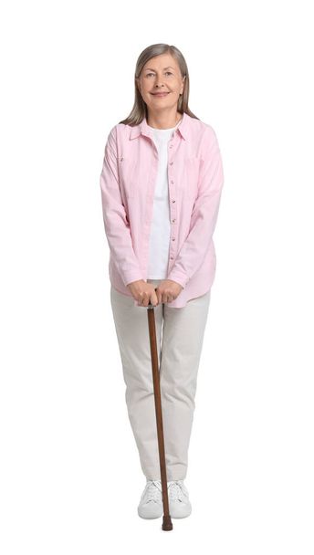 Senior woman with walking cane on white background - Fotoğraf, Görsel