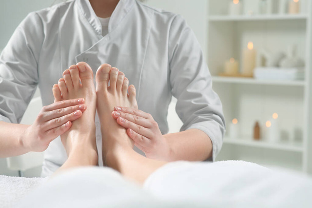 Woman receiving feet massage in spa salon, closeup - Photo, image