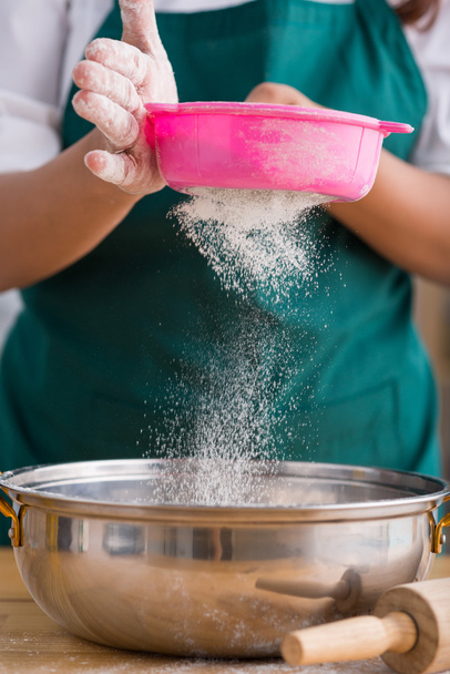 Housewife sifting flour - 写真・画像