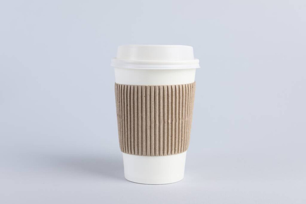 Paper cup with plastic lid on light background. Coffee to go - Photo, image
