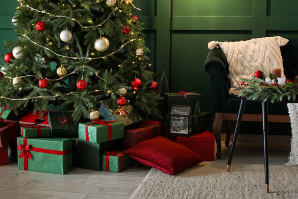 Interior of living room with Christmas tree, gift boxes and sofa - Photo, Image