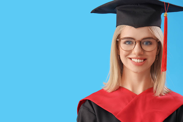 Female graduate student with diploma on blue background, closeup - Photo, image