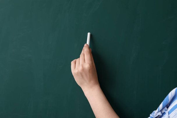 Female teacher near chalkboard in classroom, closeup - Photo, Image