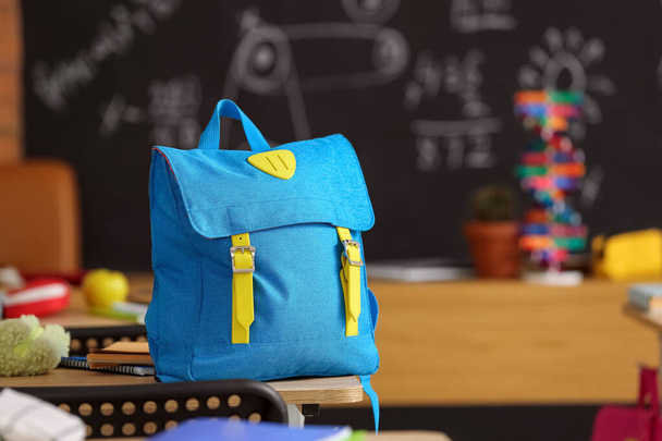 Backpack on desk in classroom - Photo, Image