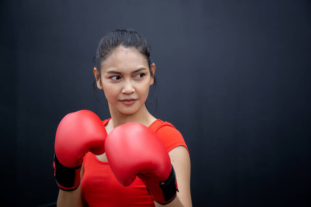 Determination of young asian woman having motivation boxing in fitness gym, active sport and workout, training boxing with strength and confidence, health and wellness, exercise and punch with cardio. - Φωτογραφία, εικόνα