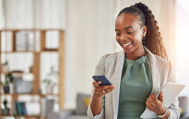 Happy black woman, phone and communication at office with smile in networking or social media. African female person or employee enjoying online browsing or chat on mobile smartphone app at workplace. - Foto, imagen