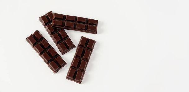 homemade dark chocolate in tiles, on a white background, place for text, banner - Photo, Image