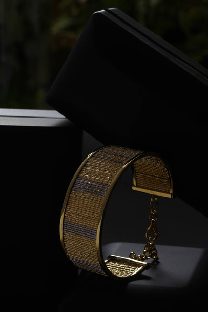 Jewelry box with stylish golden bijouterie, closeup view - Foto, imagen