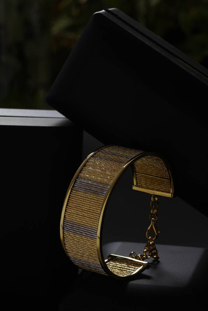 Jewelry box with stylish golden bijouterie, closeup view - Fotó, kép