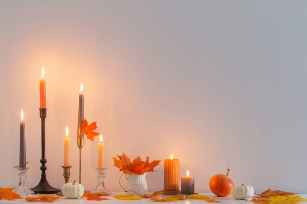 beautiful autumn home decor with burning candles in white interior - Zdjęcie, obraz