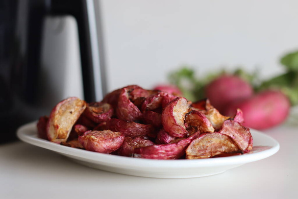 Air fried table radish. A table radish dish made by marinating it with olive oil, herbs and air fried. Shot along with air fryer and a bunch of fresh radish. - Photo, Image
