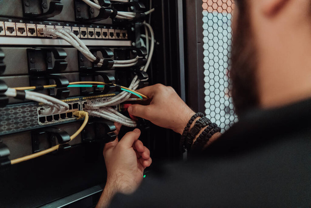 Close up of technician setting up network in server room .  - Fotografie, Obrázek