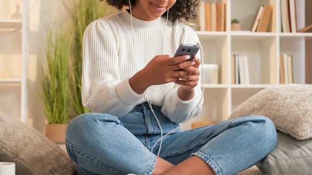 Mobile chatting. Social network. Digital communication. Millennial woman texting sms message on phone sitting sofa cozy home. - Fotó, kép