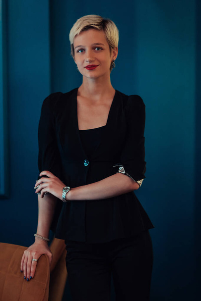Blonde business woman, successful confidence on modern blue mat background. Selective focus.  - Valokuva, kuva