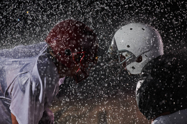 Two american football players face to face in silhouette shadow on white background.  - Φωτογραφία, εικόνα