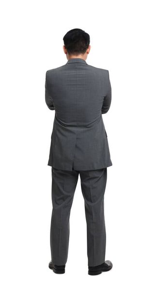 Businessman in suit posing on white background, back view - Foto, imagen