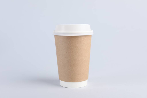Paper cup with plastic lid on light background. Coffee to go - Fotó, kép