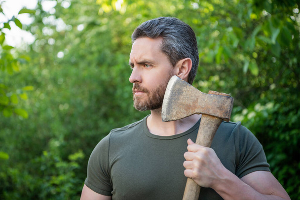 caucasian bearded masculine guy with axe. masculine guy with axe outdoor. photo of masculine guy with axe. masculine guy with axe. - Fotoğraf, Görsel