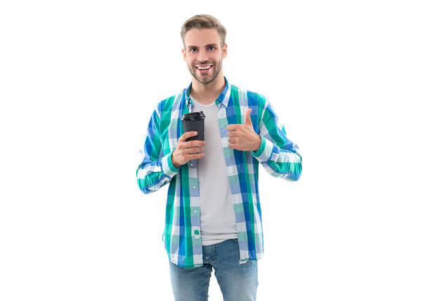 photo of millennial man with coffee, thumb up. millennial man with coffee isolated on white. millennial man with coffee in studio. millennial man with coffee on background. - Photo, image