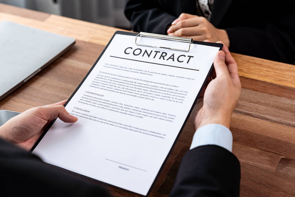 Businessman review agreement document before signing contract. Reading carefully to ensure trade deal align with business goals. Professionalism for business decision making concept. Jubilant - Фото, изображение