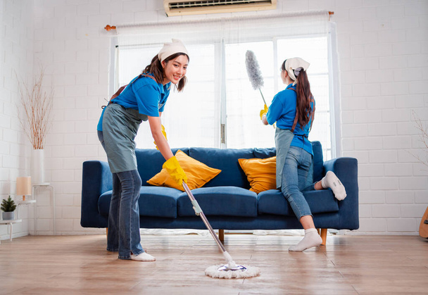 Housework or house keeping service two female cleaning dust in home, cleaning agency small business. professional equipment cleaning old home. - Photo, Image