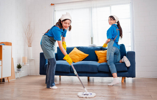 Housework or house keeping service two female cleaning dust in home, cleaning agency small business. professional equipment cleaning old home. - Фото, зображення